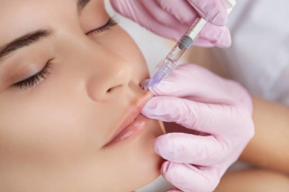 a patient receiving botox and filler treatment injections from a physician