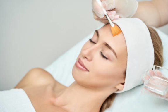 Cosmetology beauty procedure. Young woman skin care. Beautiful female person. Rejuvenation treatment. Facial chemical peel therapy. Clinical healthcare. Doctor hand. Dermatology cleanser.